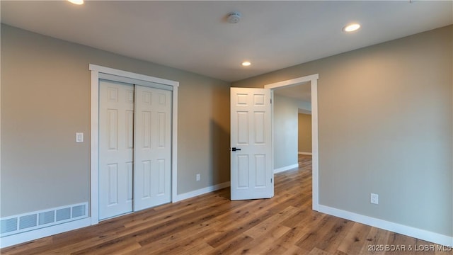 1129 Ginger Rd, Lake Ozark, MO 65049 - unfurnished bedroom featuring wood finished floors, recessed lighting, and a closet