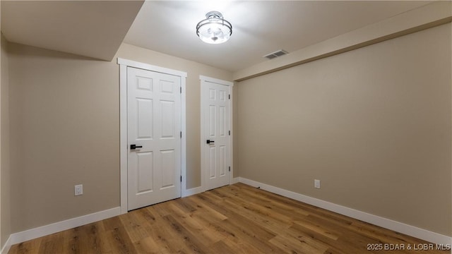 unfurnished bedroom featuring baseboards and light wood-style flooring