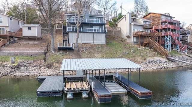 dock area with stairway and a water view