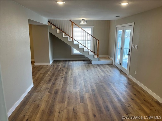 entryway featuring stairs, wood finished floors, and baseboards