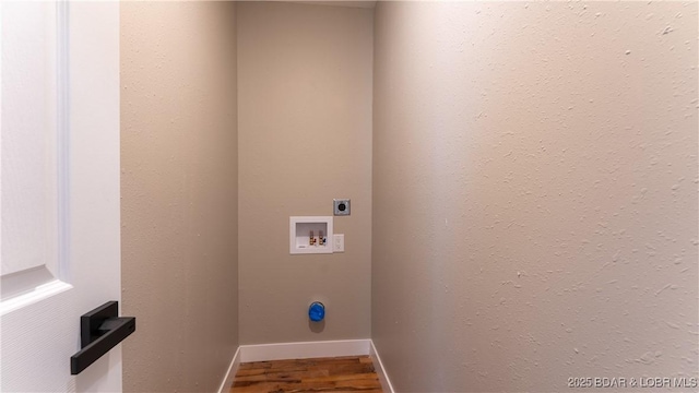 clothes washing area featuring hookup for an electric dryer, washer hookup, wood finished floors, and baseboards
