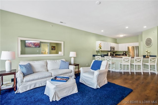 living area featuring wood finished floors and recessed lighting