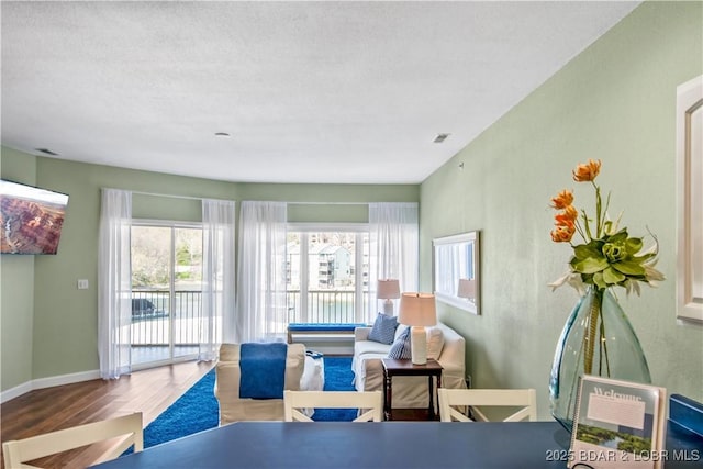 living room with wood finished floors and baseboards