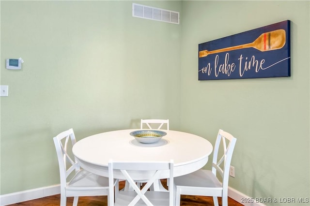 dining room featuring baseboards and wood finished floors