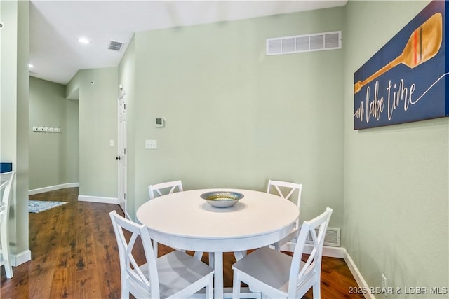 dining room with wood finished floors, baseboards, and recessed lighting