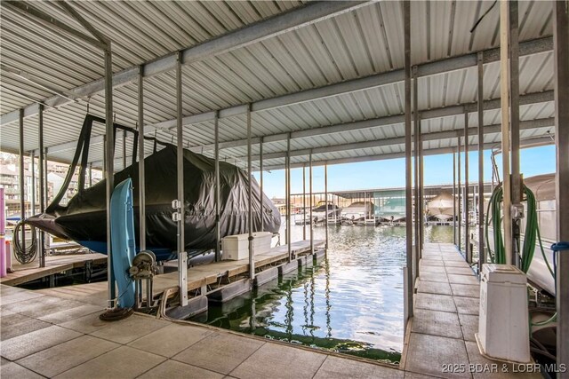 dock area featuring boat lift and a water view