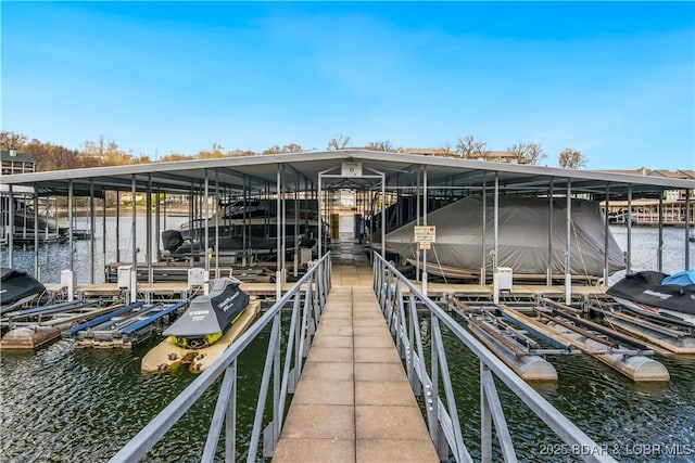 dock area featuring boat lift and a water view
