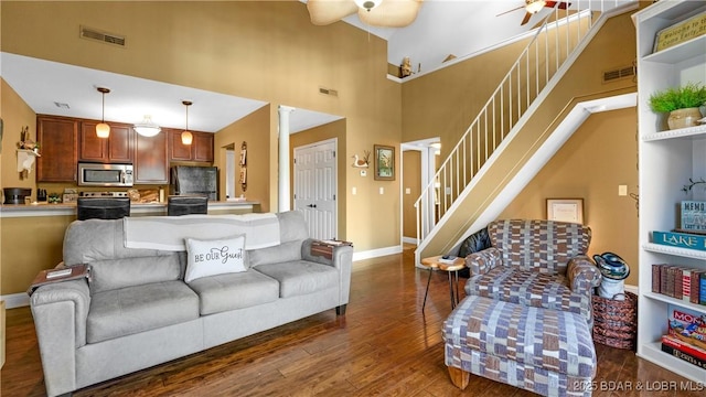 1034 Indian Pointe Unit 1034, Osage Beach, MO 65065 - living room featuring stairs, a ceiling fan, dark wood finished floors, baseboards, and a towering ceiling