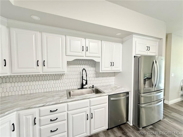 245 Davis Dr, Holts Summit, MO 65043 - kitchen with white cabinets, dark wood-style floors, light countertops, a sink, and appliances with stainless steel finishes