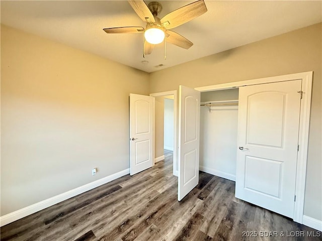 245 Davis Dr, Holts Summit, MO 65043 - unfurnished bedroom featuring ceiling fan, a closet, baseboards, and dark wood-style flooring