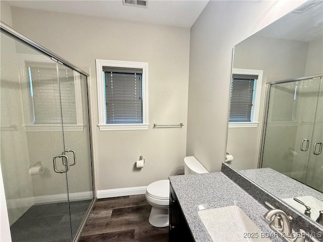 245 Davis Dr, Holts Summit, MO 65043 - full bathroom featuring toilet, a stall shower, wood finished floors, and baseboards