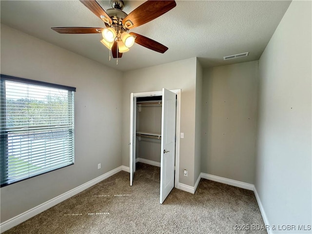 245 Davis Dr, Holts Summit, MO 65043 - unfurnished bedroom featuring a closet, multiple windows, visible vents, and carpet