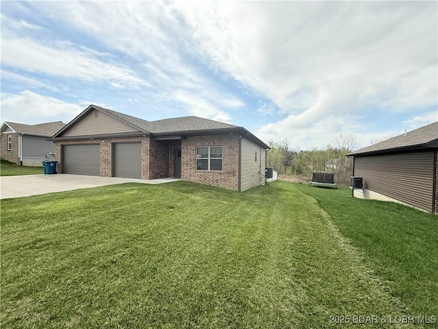 245 Davis Dr, Holts Summit, MO 65043 - view of front facade featuring an attached garage, a front lawn, driveway, and brick siding