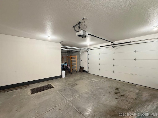 245 Davis Dr, Holts Summit, MO 65043 - garage with baseboards and a garage door opener