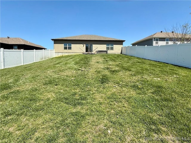 245 Davis Dr, Holts Summit, MO 65043 - rear view of house featuring a fenced backyard and a yard