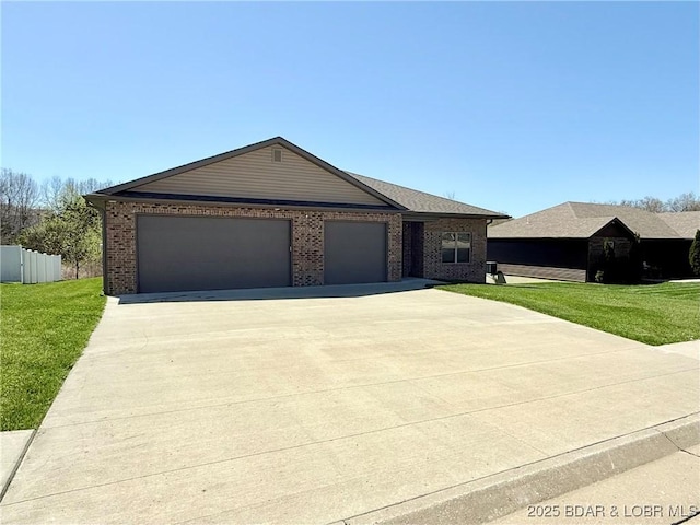245 Davis Dr, Holts Summit, MO 65043 - single story home featuring a garage, driveway, a front lawn, and brick siding