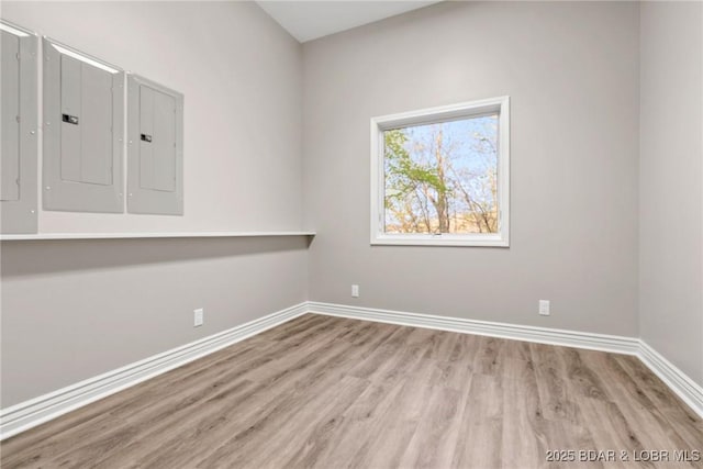275 Waterford Ter, Sunrise Beach, MO 65079 - empty room featuring baseboards, wood finished floors, and electric panel