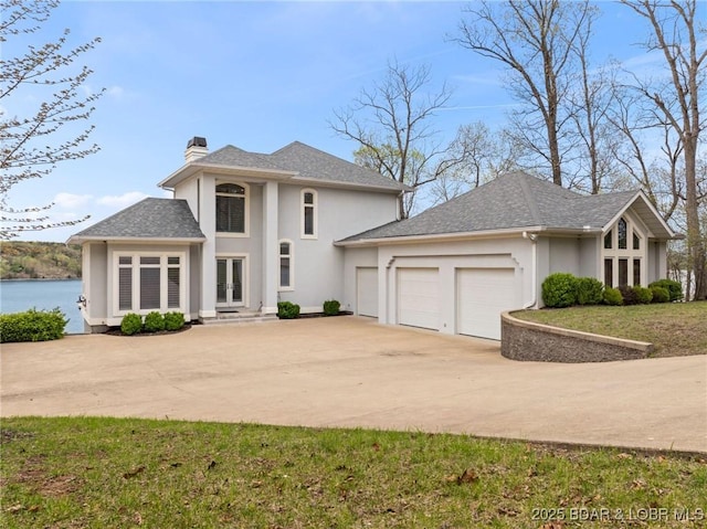 275 Waterford Ter, Sunrise Beach, MO 65079 - view of front of home featuring french doors, a chimney, concrete driveway, a garage, and stucco siding