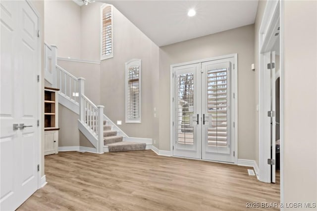 275 Waterford Ter, Sunrise Beach, MO 65079 - entryway with baseboards, light wood-type flooring, stairs, and french doors