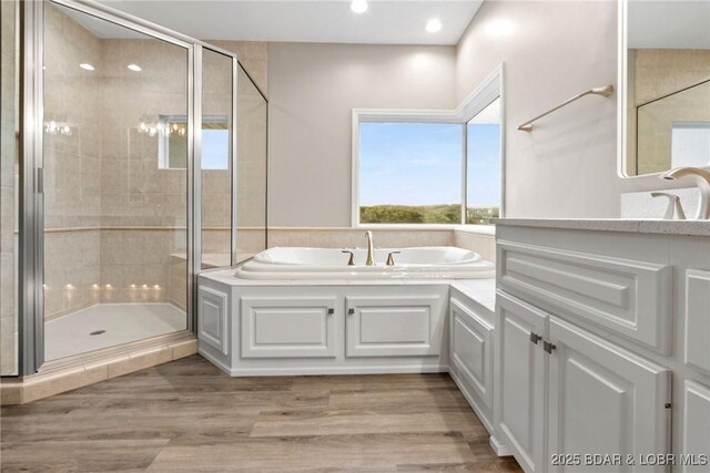 275 Waterford Ter, Sunrise Beach, MO 65079 - full bath with recessed lighting, a garden tub, wood finished floors, and a stall shower