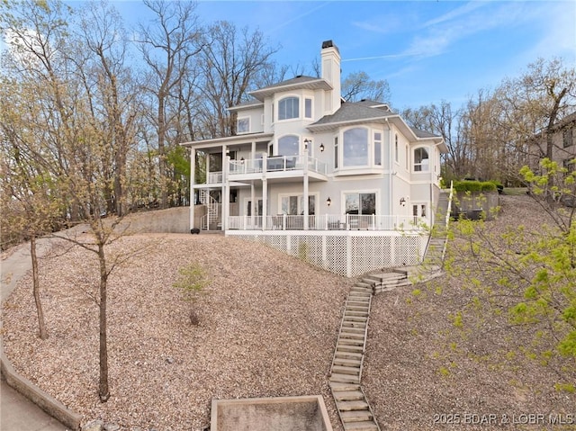 275 Waterford Ter, Sunrise Beach, MO 65079 - rear view of property with stairway, a chimney, and a balcony