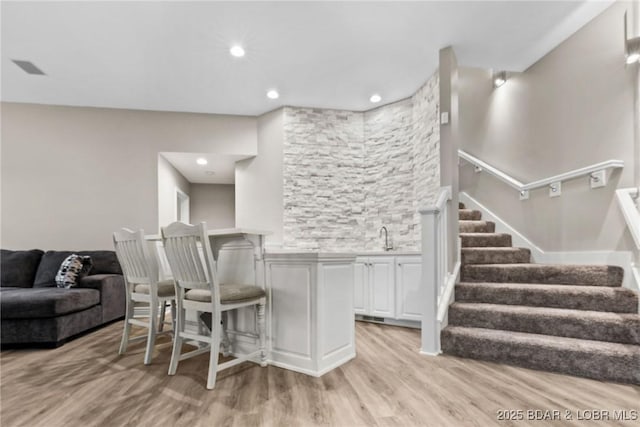 275 Waterford Ter, Sunrise Beach, MO 65079 - bar featuring recessed lighting, stairway, a sink, light wood-style floors, and indoor wet bar