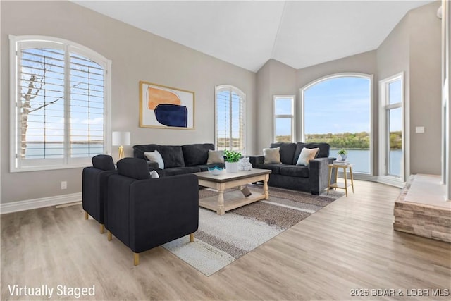 275 Waterford Ter, Sunrise Beach, MO 65079 - living area featuring vaulted ceiling, wood finished floors, and plenty of natural light