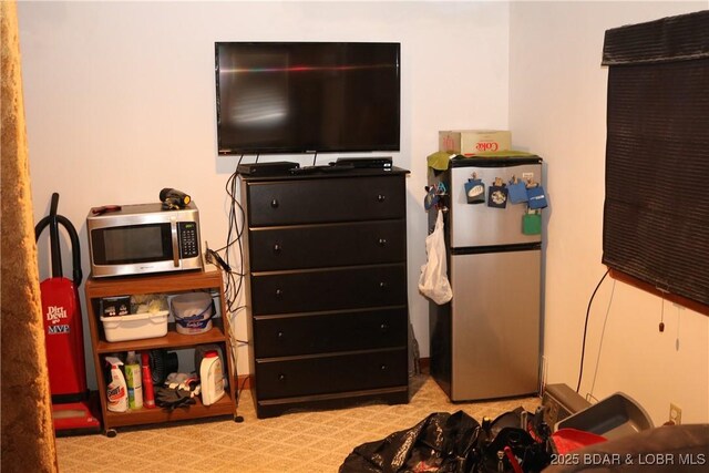 30718 Honeysuckle Rd, Gravois Mills, MO 65037 - bedroom with freestanding refrigerator