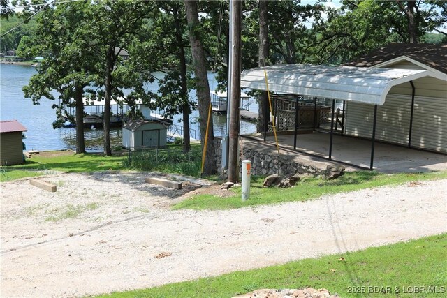 30718 Honeysuckle Rd, Gravois Mills, MO 65037 - exterior space with a shed, a water view, and a detached carport
