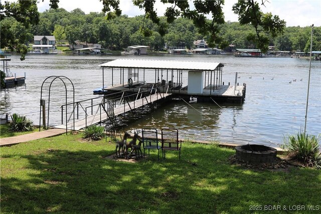 30718 Honeysuckle Rd, Gravois Mills, MO 65037 - dock area with a fire pit, boat lift, a lawn, and a water view