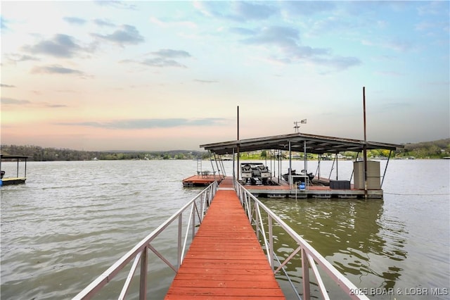 view of dock with boat lift and a water view