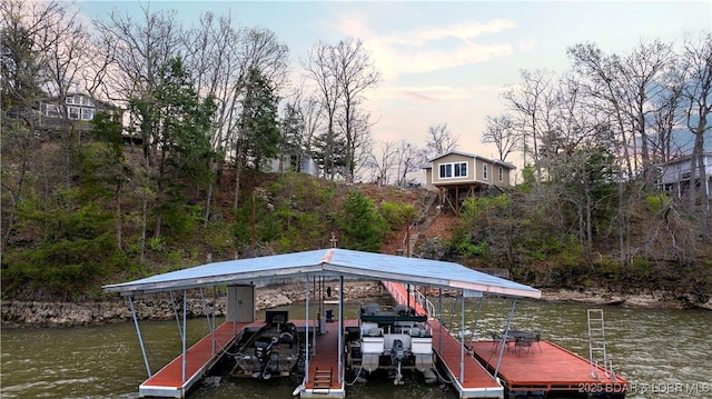 dock area featuring boat lift and a water view