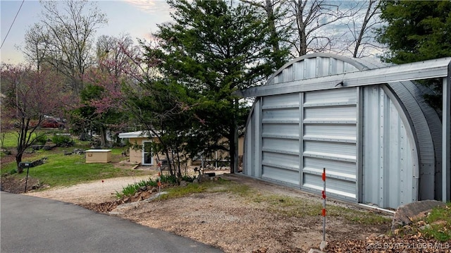 garage with dirt driveway