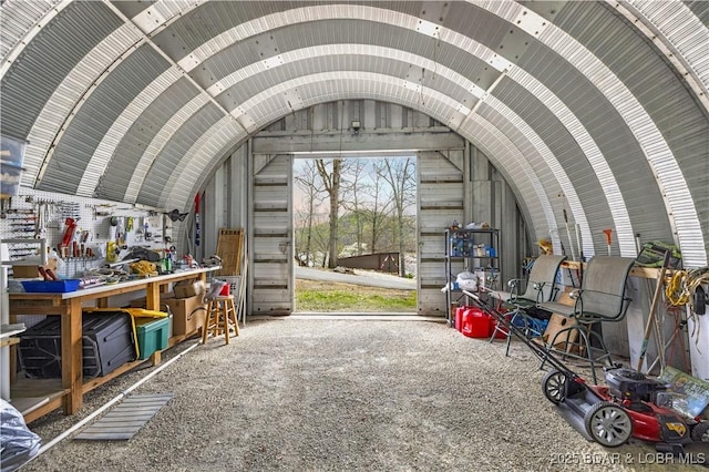 misc room with lofted ceiling and a workshop area