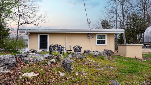 back of property featuring concrete block siding