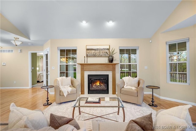 101 Cliffstone Ln, Sunrise Beach, MO 65079 - living area featuring lofted ceiling, baseboards, a fireplace, and wood finished floors
