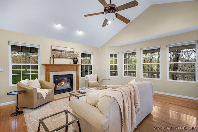 101 Cliffstone Ln, Sunrise Beach, MO 65079 - living area with baseboards, a fireplace with flush hearth, high vaulted ceiling, a ceiling fan, and wood-type flooring