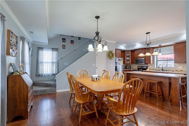 dining room featuring dark wood-style floors, baseboards, a notable chandelier, stairway, and crown molding