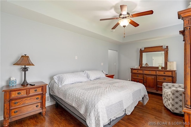 bedroom featuring a ceiling fan and dark wood-style floors