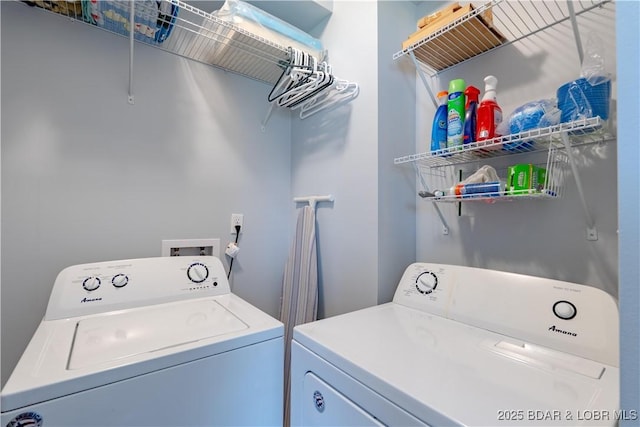clothes washing area with washing machine and clothes dryer and laundry area
