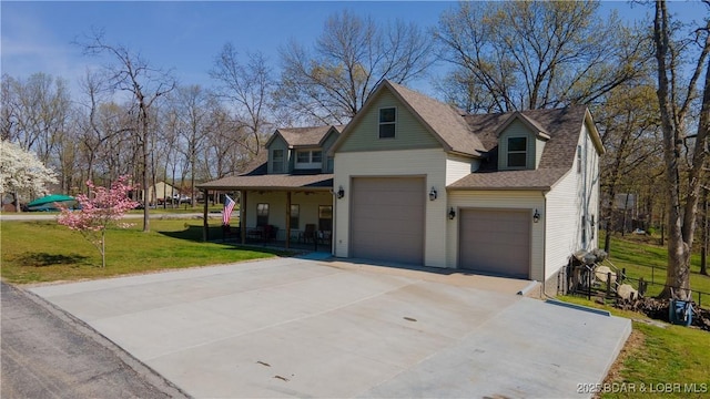 view of front of home with fence, driveway, covered porch, a front yard, and a garage