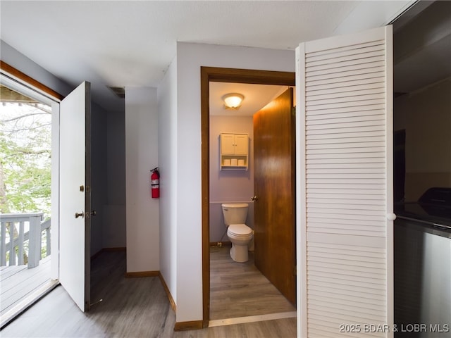 24930 Leona Ln, Versailles, MO 65084 - bathroom with visible vents, baseboards, wood finished floors, and toilet