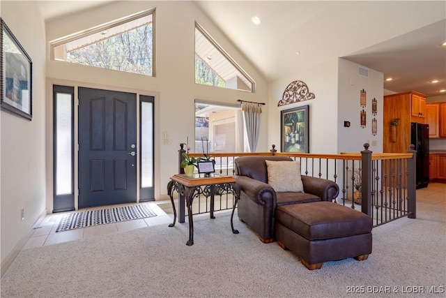 6605 Saint Moritz Dr, Osage Beach, MO 65065 - entryway featuring baseboards, high vaulted ceiling, recessed lighting, and light colored carpet