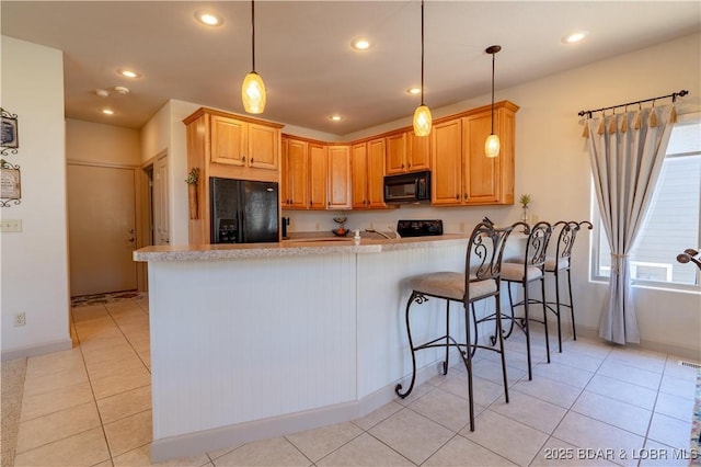 6605 Saint Moritz Dr, Osage Beach, MO 65065 - kitchen with a peninsula, light tile patterned floors, recessed lighting, and black appliances