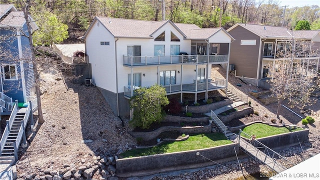 6605 Saint Moritz Dr, Osage Beach, MO 65065 - back of property featuring stairway, a balcony, and central AC unit