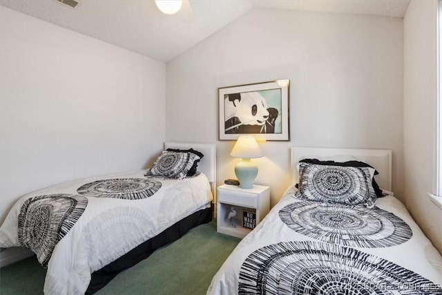 bedroom with lofted ceiling, a ceiling fan, and carpet floors