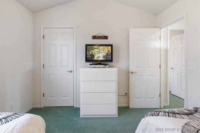 carpeted bedroom with vaulted ceiling and baseboards