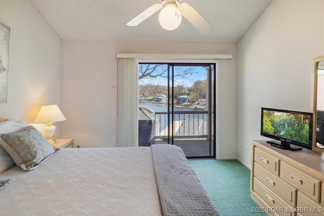 bedroom with ceiling fan, access to outside, a textured ceiling, and light colored carpet