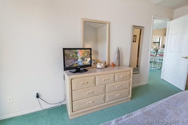 carpeted bedroom featuring baseboards