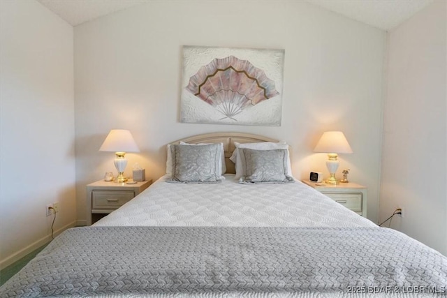 carpeted bedroom featuring vaulted ceiling and baseboards